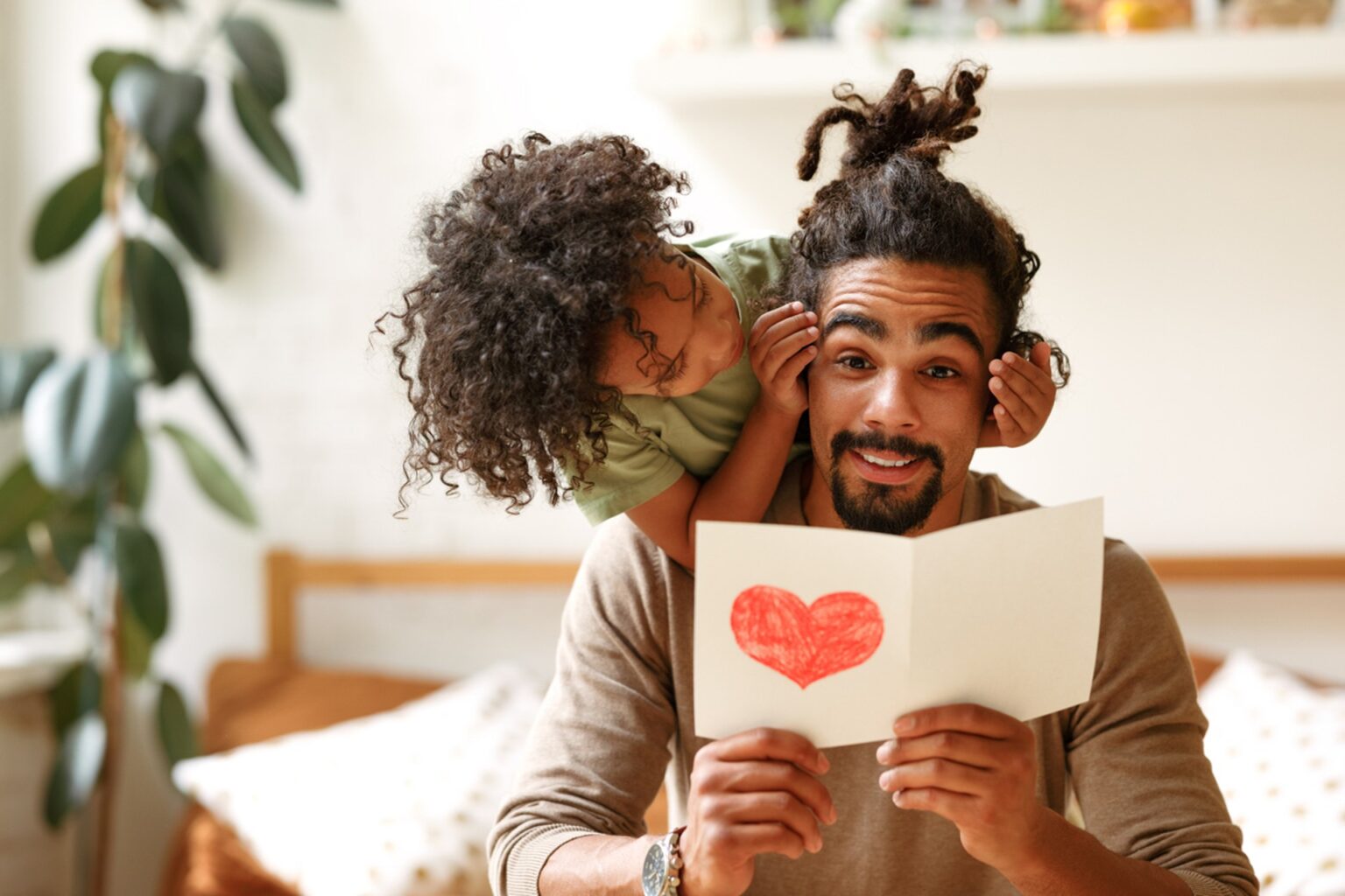 Father reads handmade card from his son for Father's Day