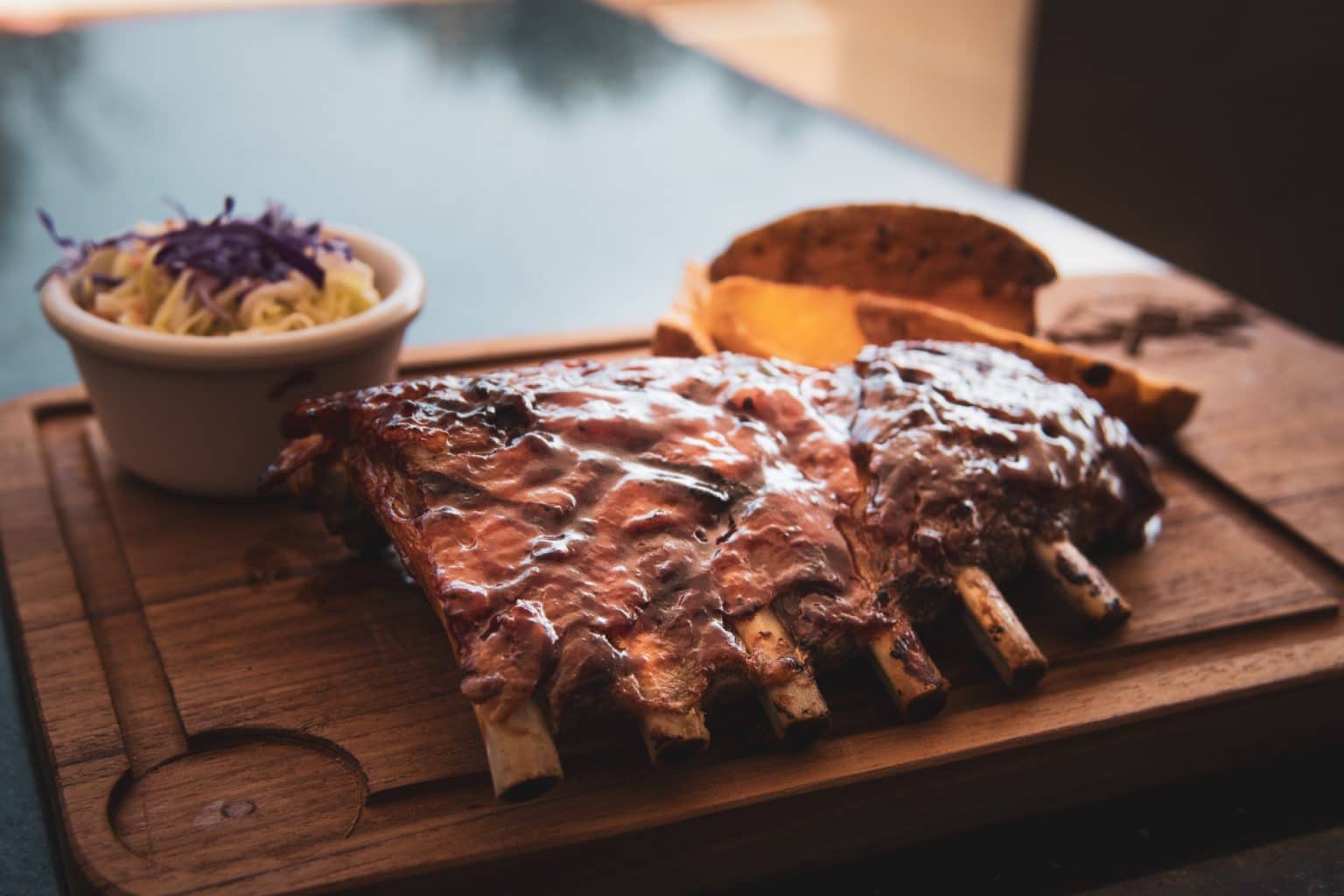 ribs on a cutting board with sauce