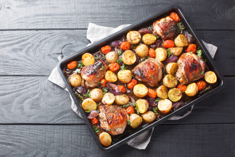 Herbed chicken tray bake on a dark countertop