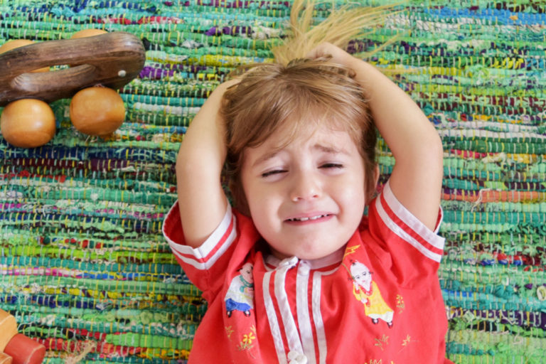 child having a temper tantrum on the floor