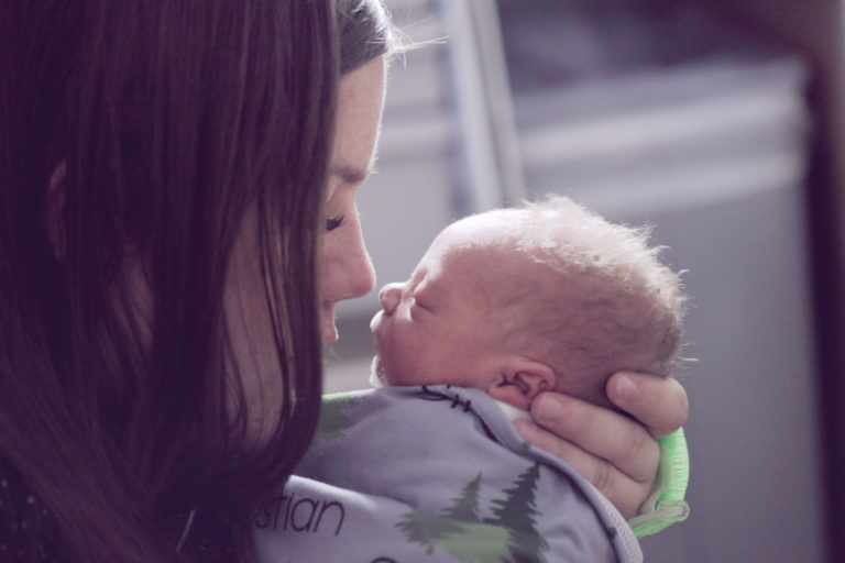 mother nuzzling her newborn baby