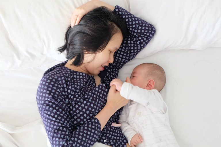 woman and baby in bed