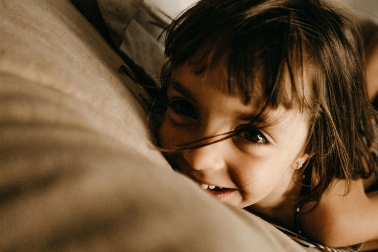 little girl laying on a couch