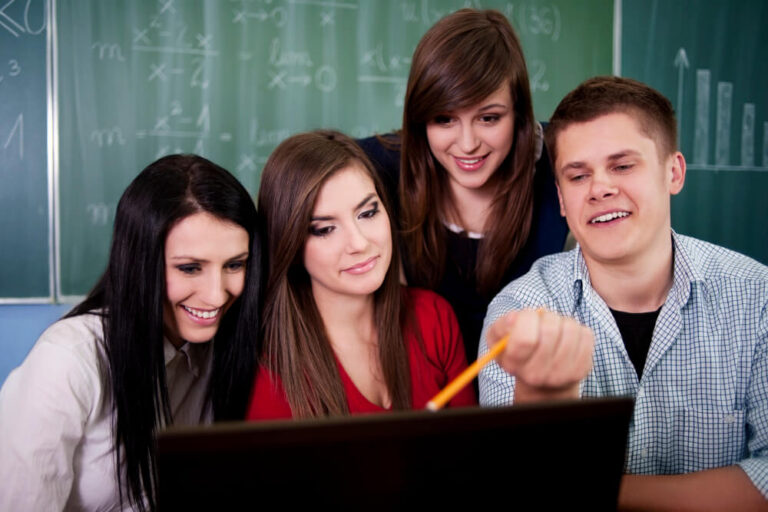 a group of people looking at a computer screen