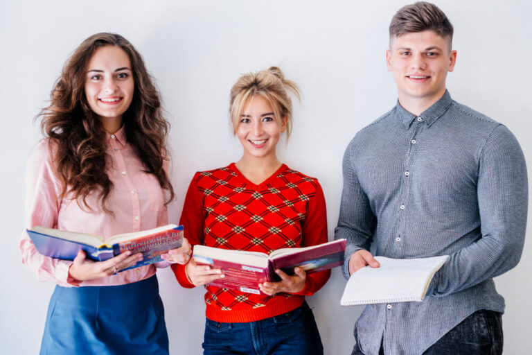 a group of people holding books