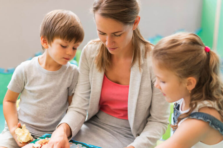 a woman and children looking at a puzzle