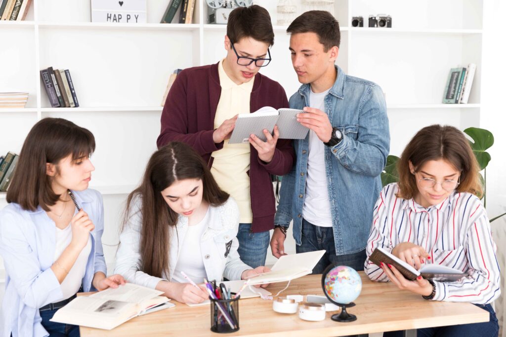 a group of people standing around a table