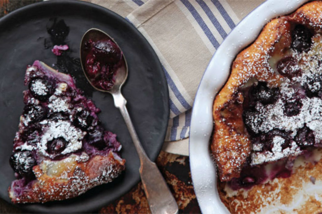 cherry pancake on a plate with icing sugar