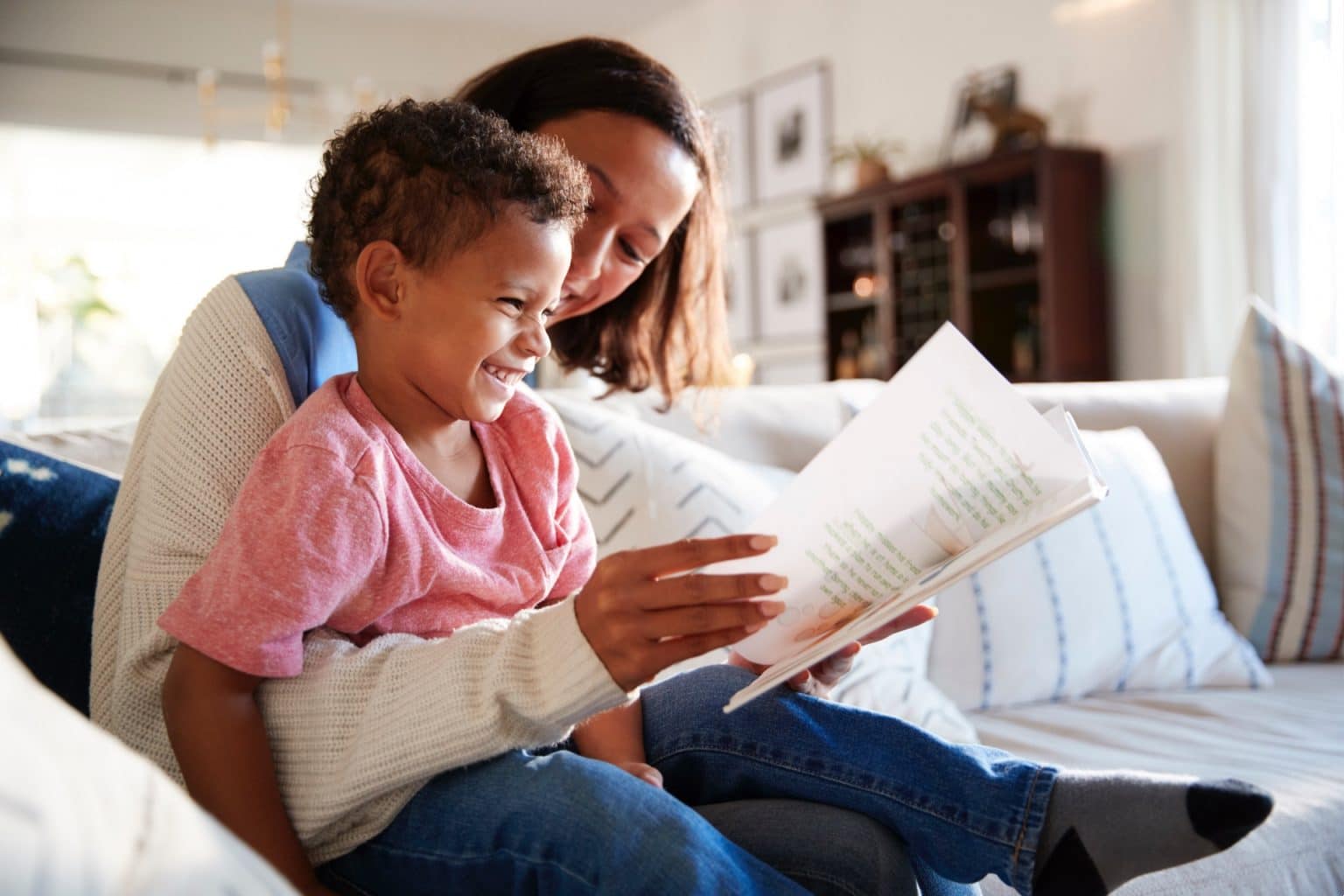 mother and son on the couch with a book