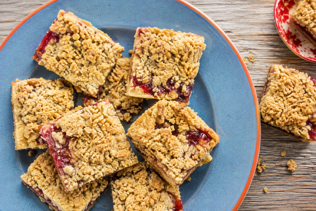 Jam crumble squares on a blue plate with a red rim