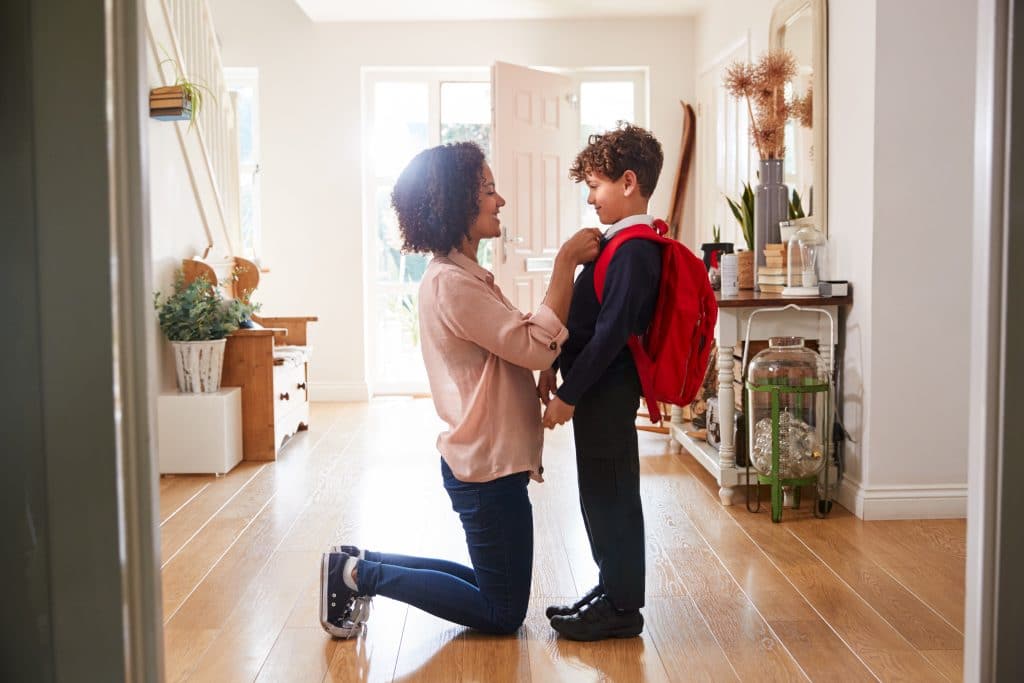 Parent and child getting ready for school, to illustrate how to help your child succeed at school