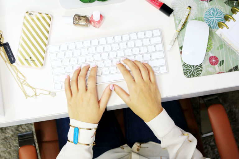 woman with her hands on a computer keyboard