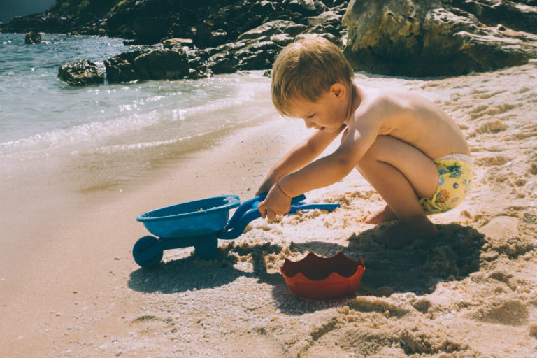 kid playing on the beach