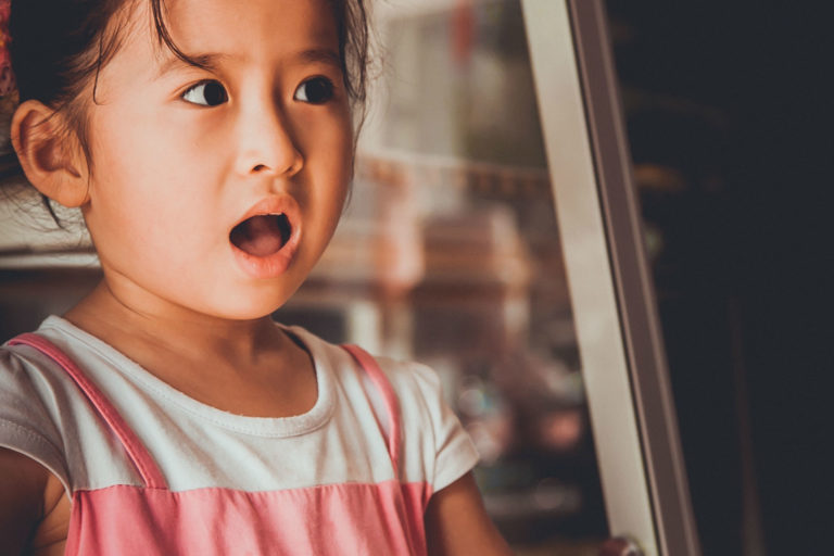 girl with her mouth open looking like she's about to report something bad
