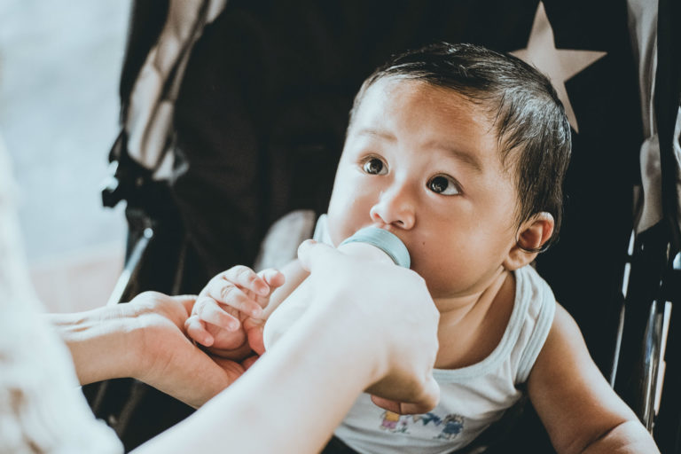 baby drinking formula from a bottle