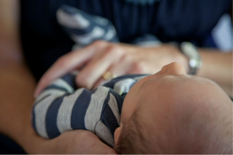 mother holding baby in her arms