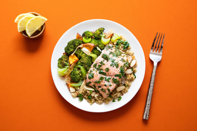 plate of salmon and greens with grains