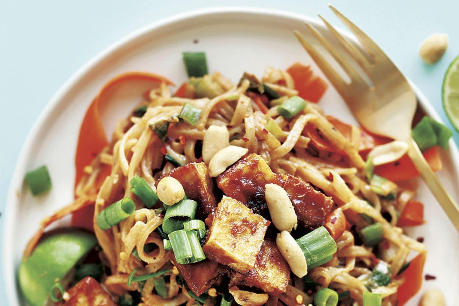 plate of pad thai with tofu and chopped peanuts