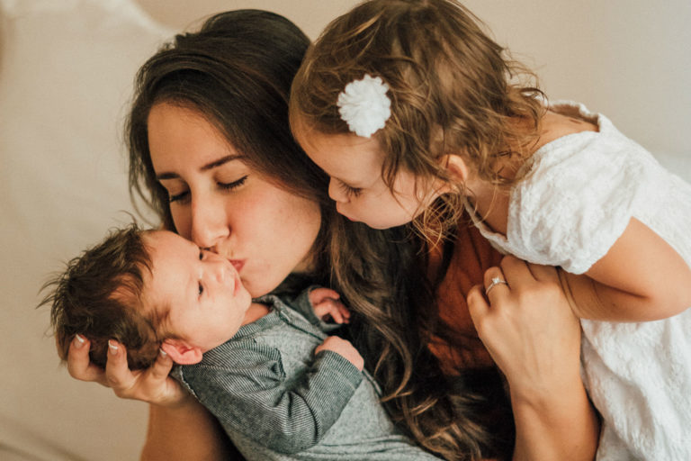 mother holding her two children