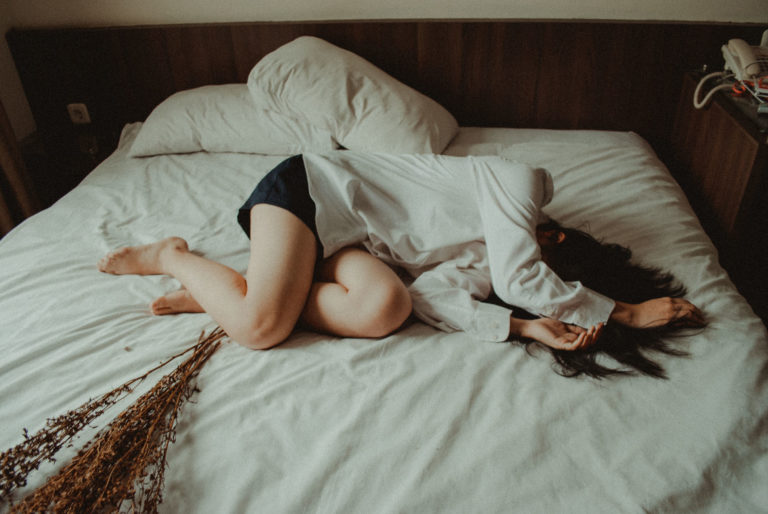 woman laying on a bed