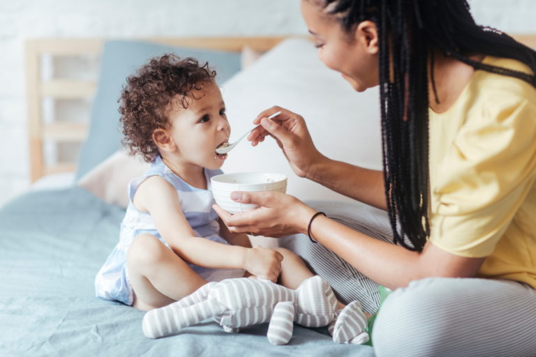Mom feeding baby cereal