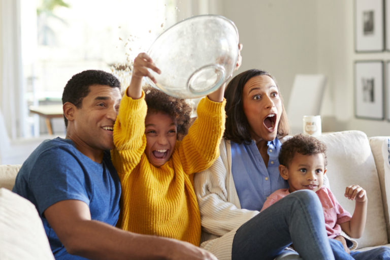 family watching a scary movie on the couch