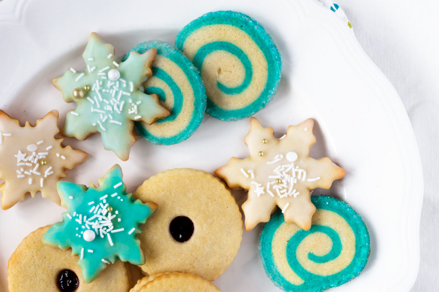 plate of sugar cookies glazed and with sprinkles