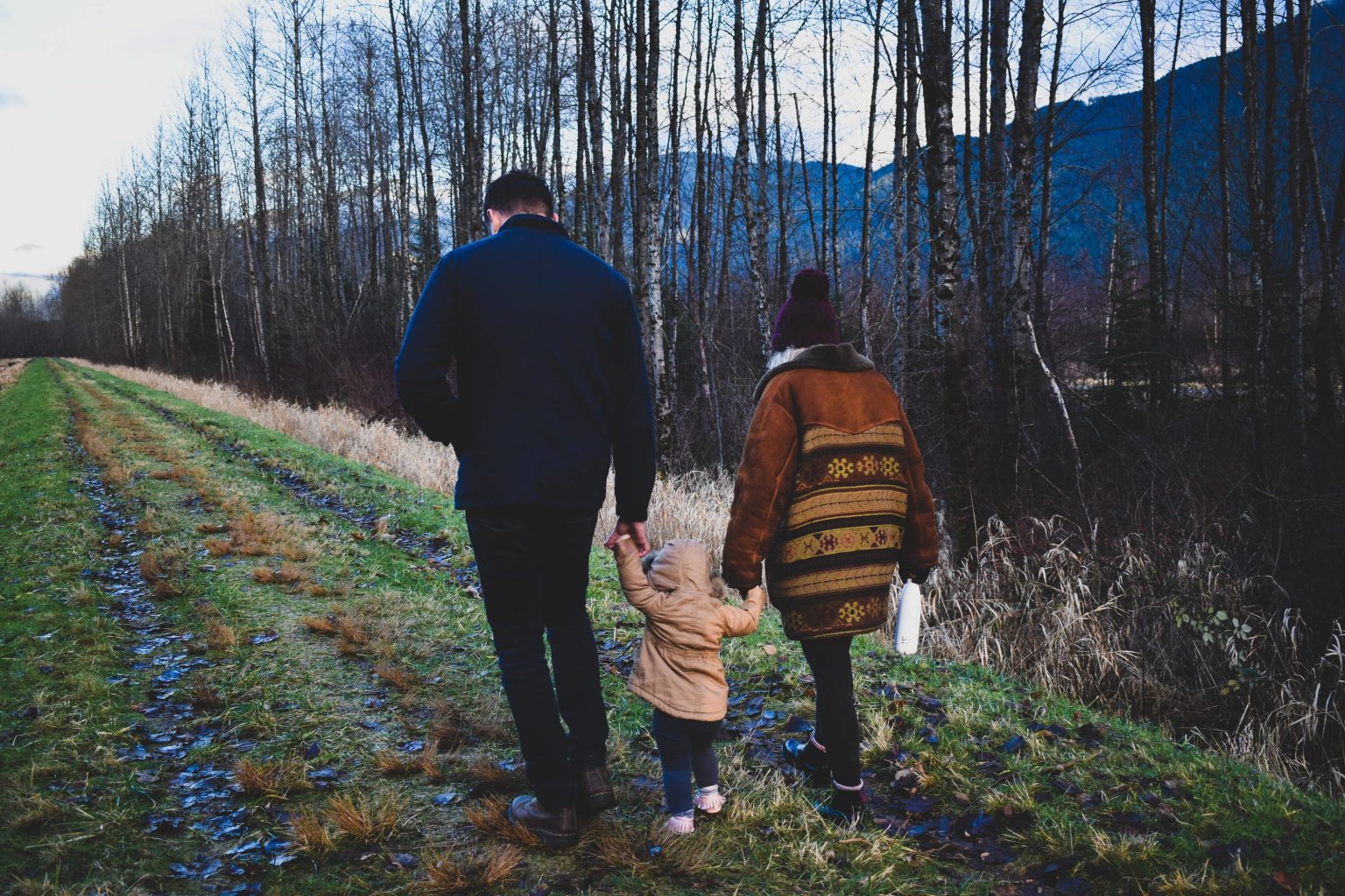 Parents and child walking away, backs to the camera