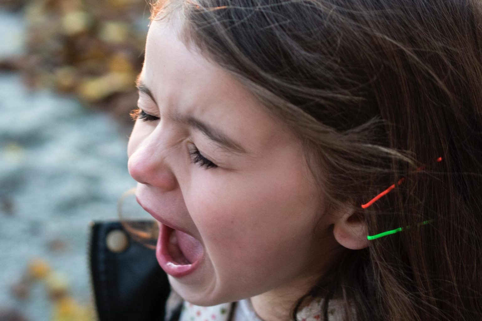 Young girl with brown hair screaming