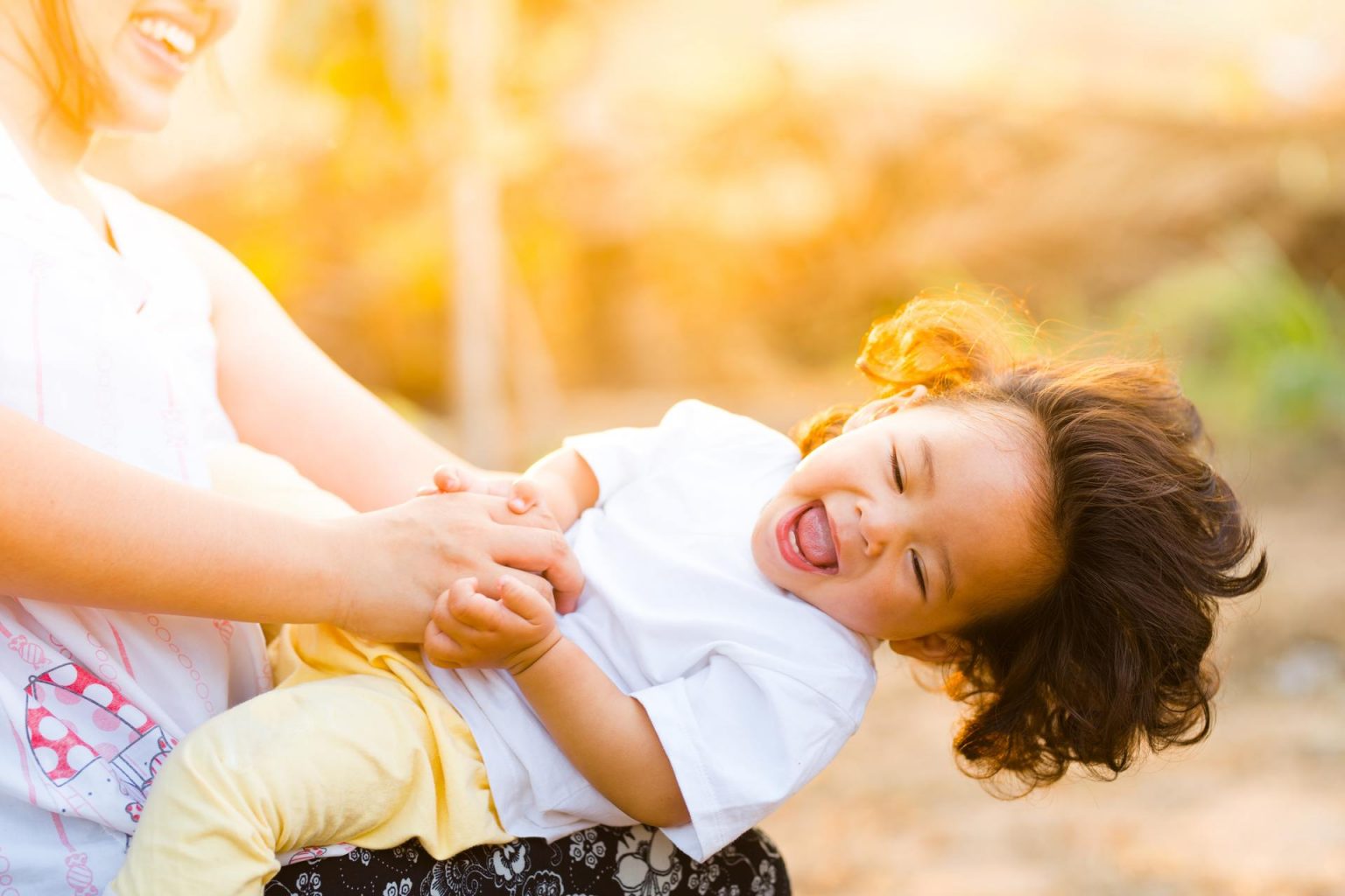 Woman swinging a toddler