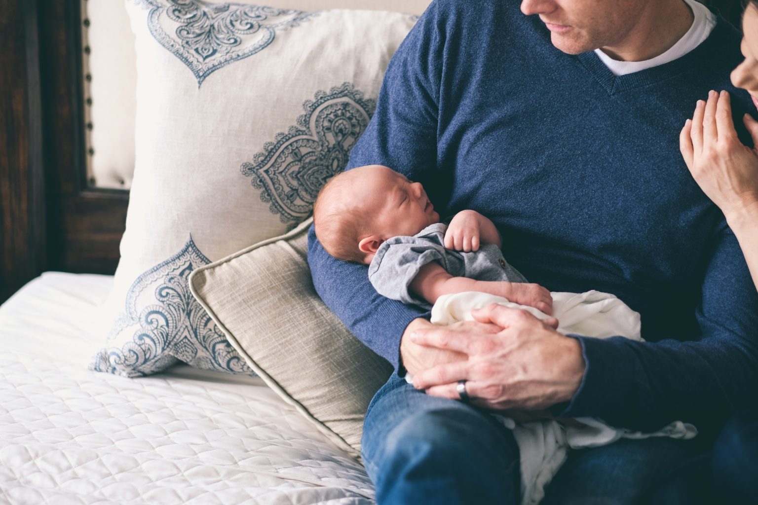 Dad worriedly looking at new baby