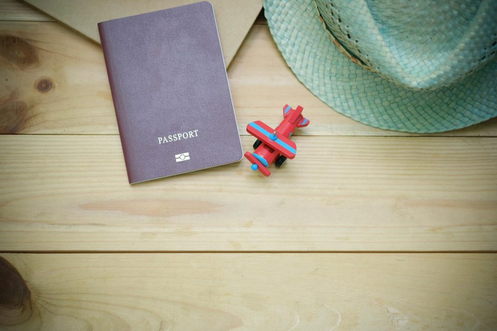 Passport and toy airplane on a desk