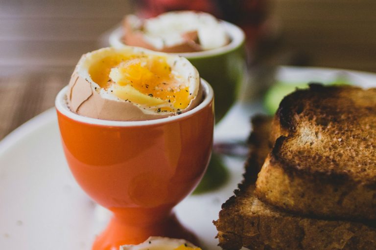 soft boiled eggs and toast on a table