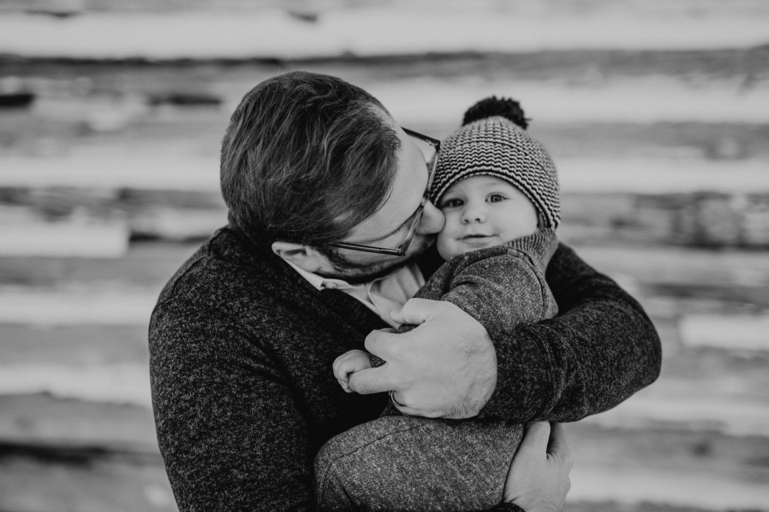 father kissing a baby