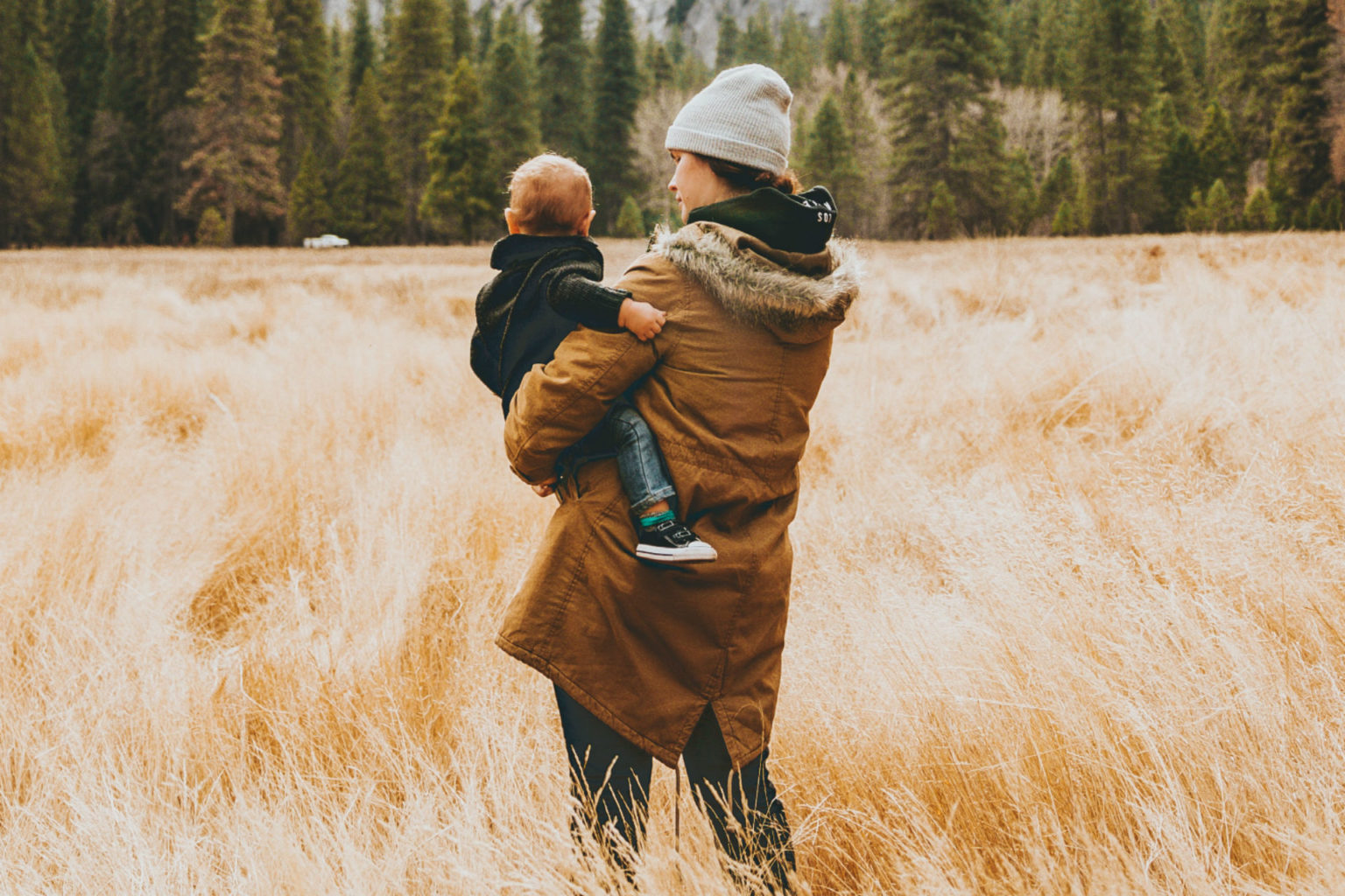 mother and son standing in a field