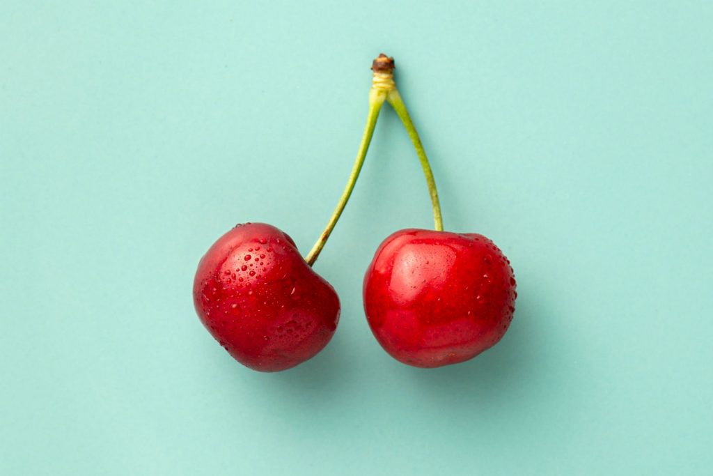 two cherries on a blue background