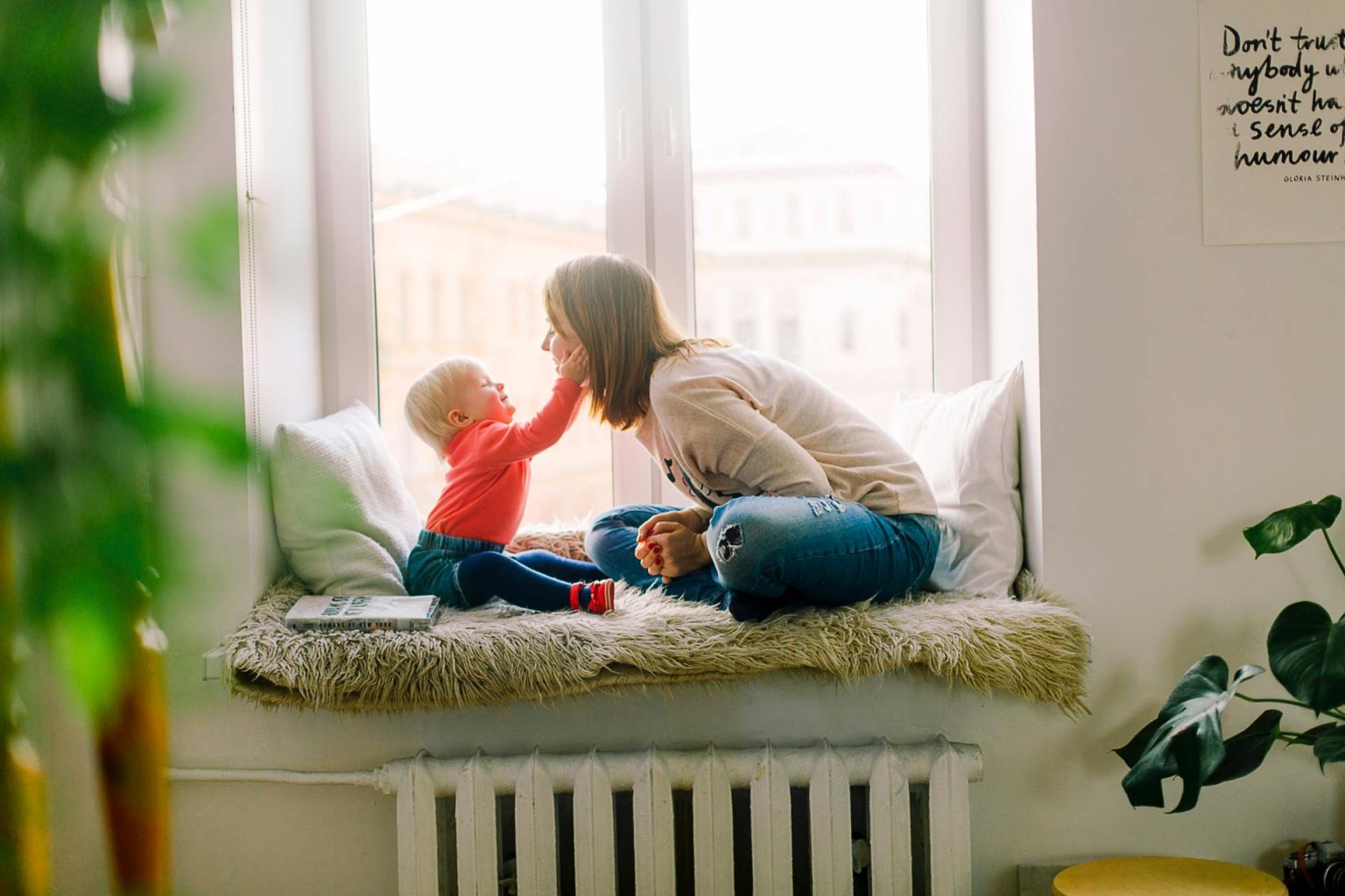 Toddler with hands on her parent's face