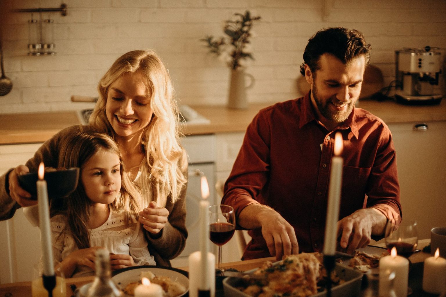 Couple with child sitting at dinner table