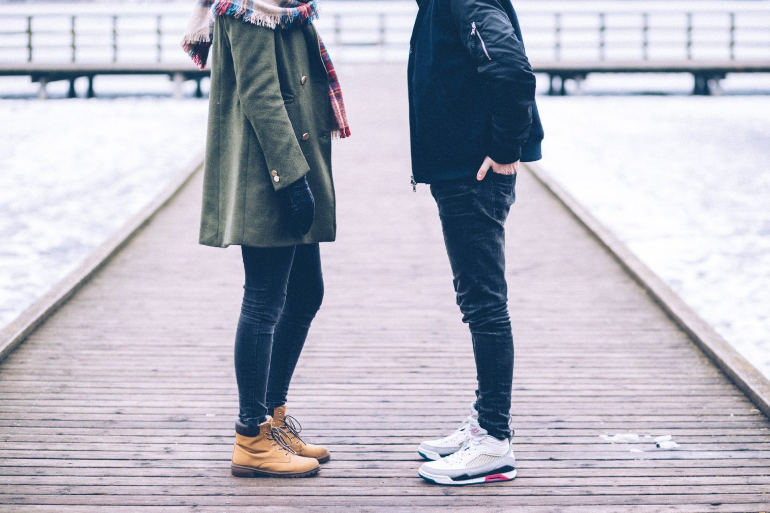 Adult couple facing each other on a dock