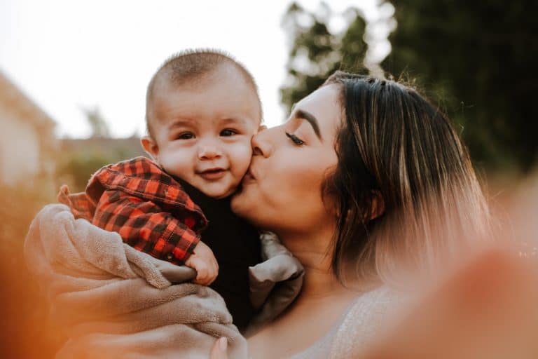 mother kissing her baby on the cheek