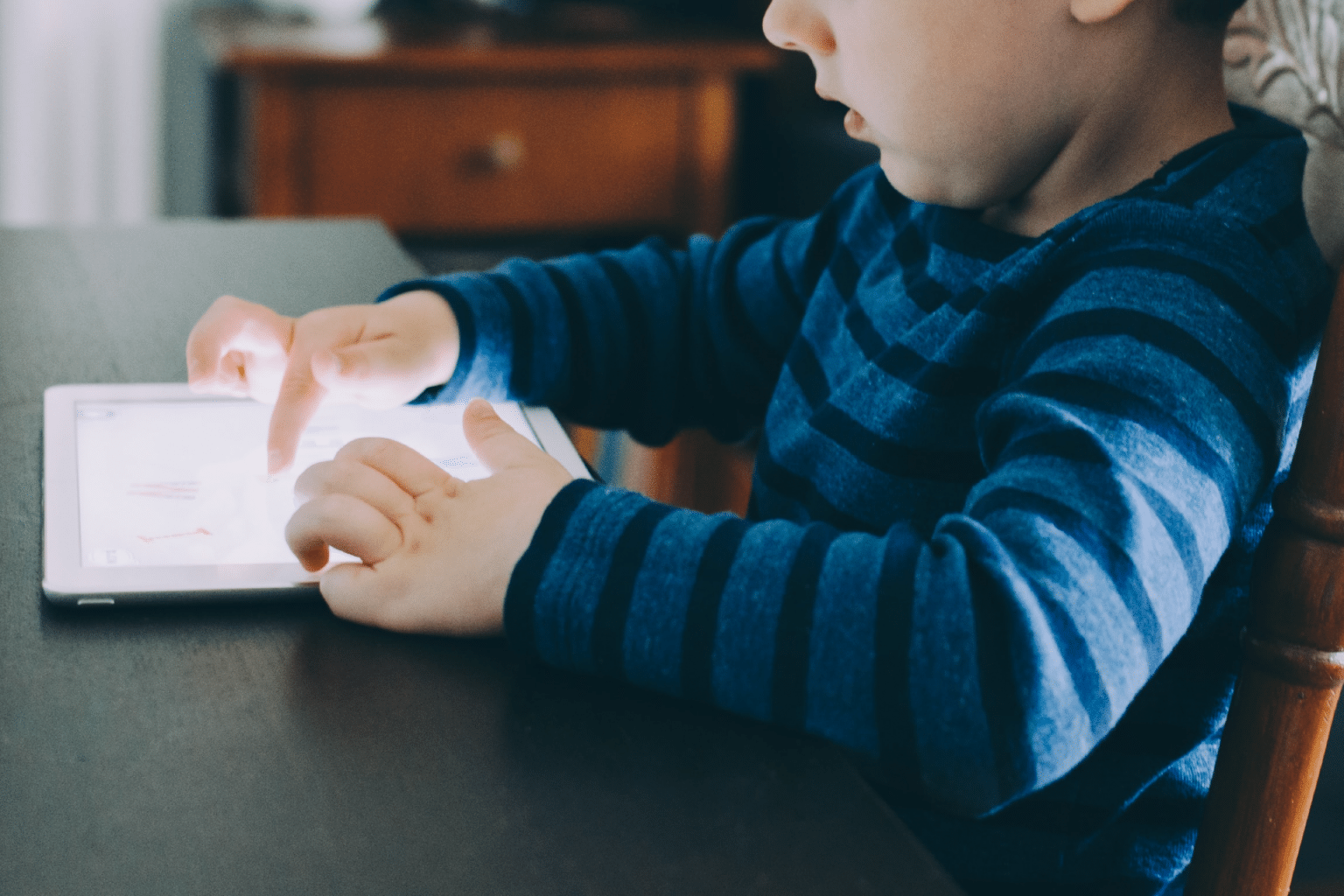 child playing on an iPad