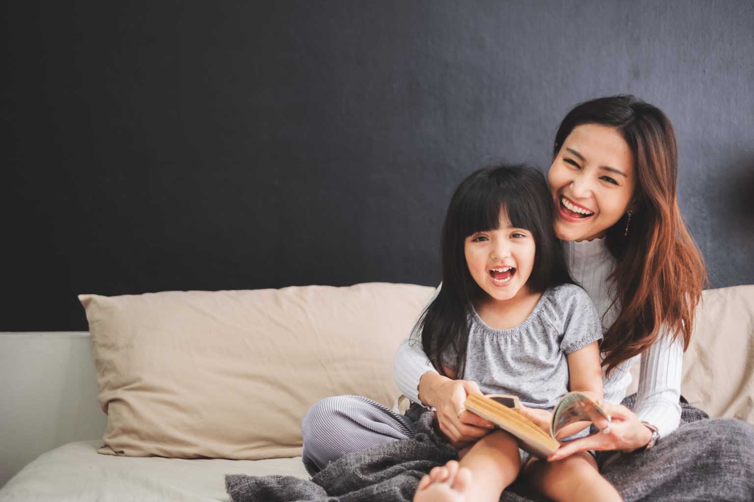 mother and daughter on the couch with a book