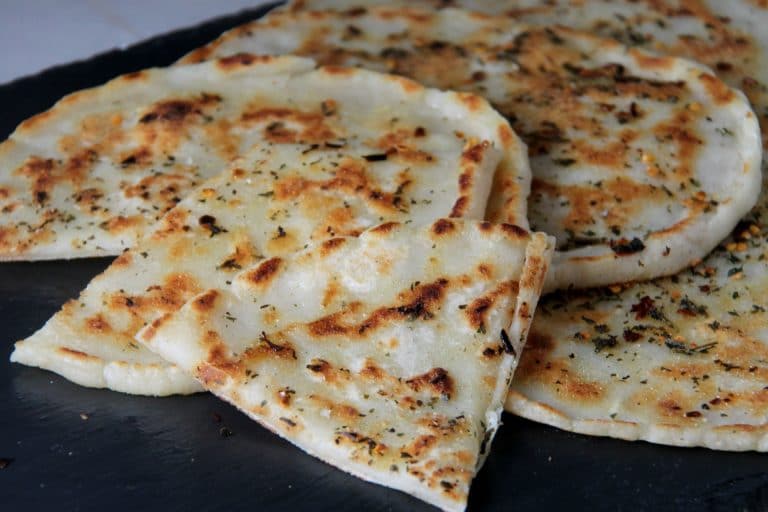 flatbread with spices cut on a plate