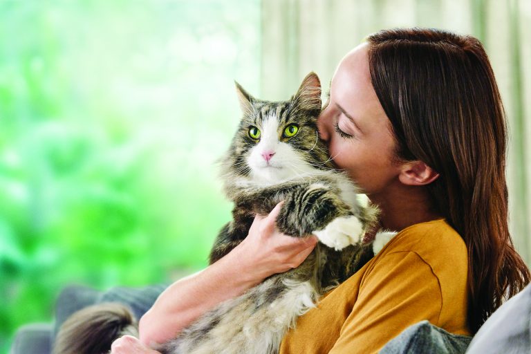 woman cuddling with her cat