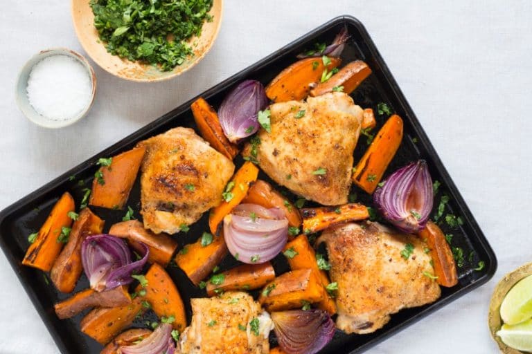 sheet pan with roasted chicken thighs and vegetables