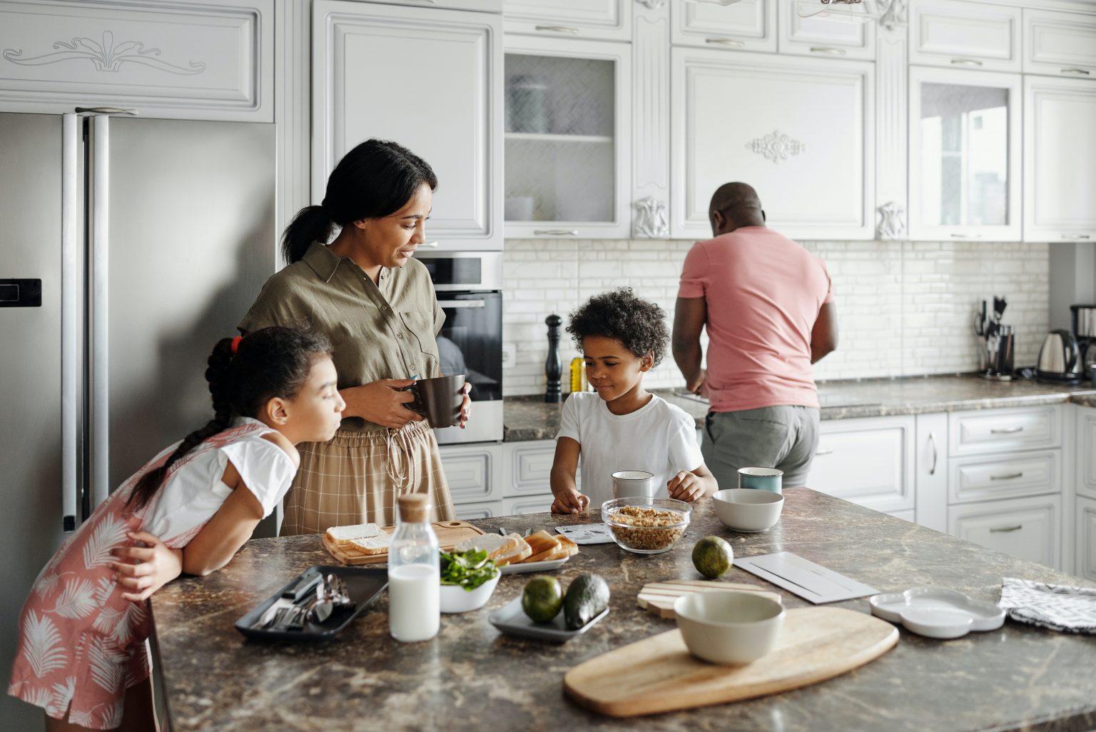 family together in a kitchen preparing a meal