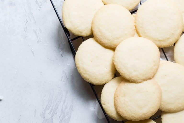 cooling rack of round coconut shortbread cookies on a counter