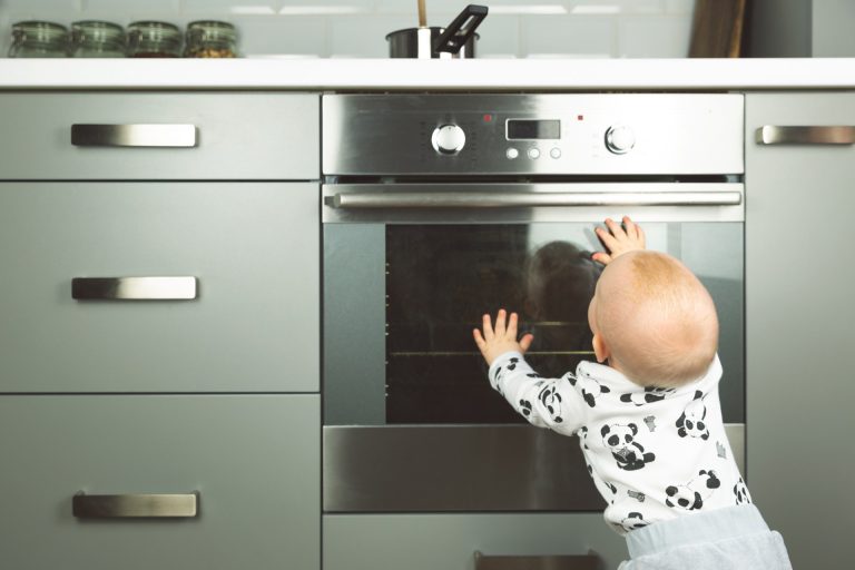 baby trying to reach the stove