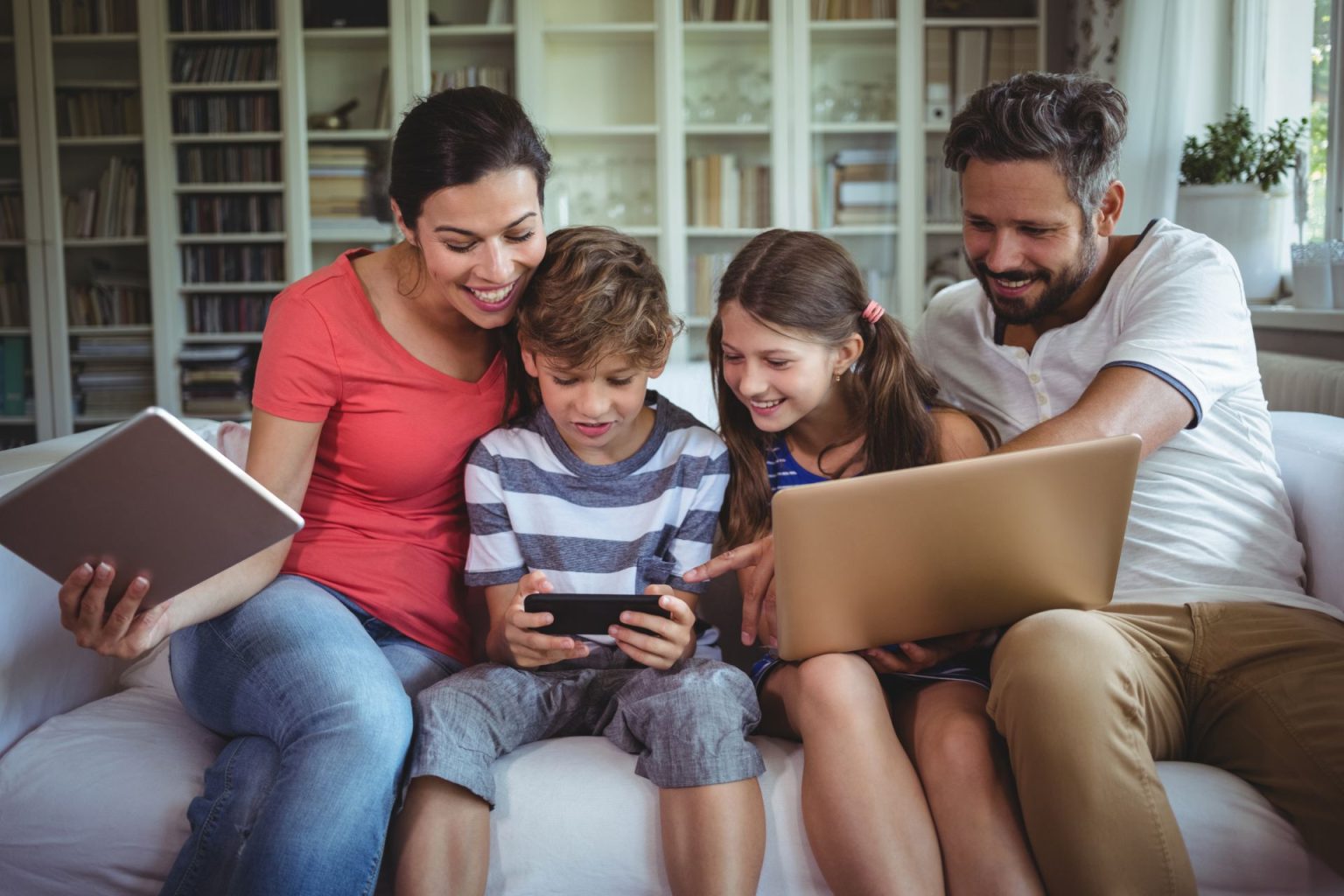 Family enjoying tech freebies on three devices