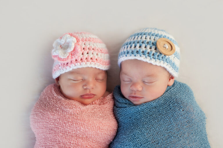 two babies wearing knit hats